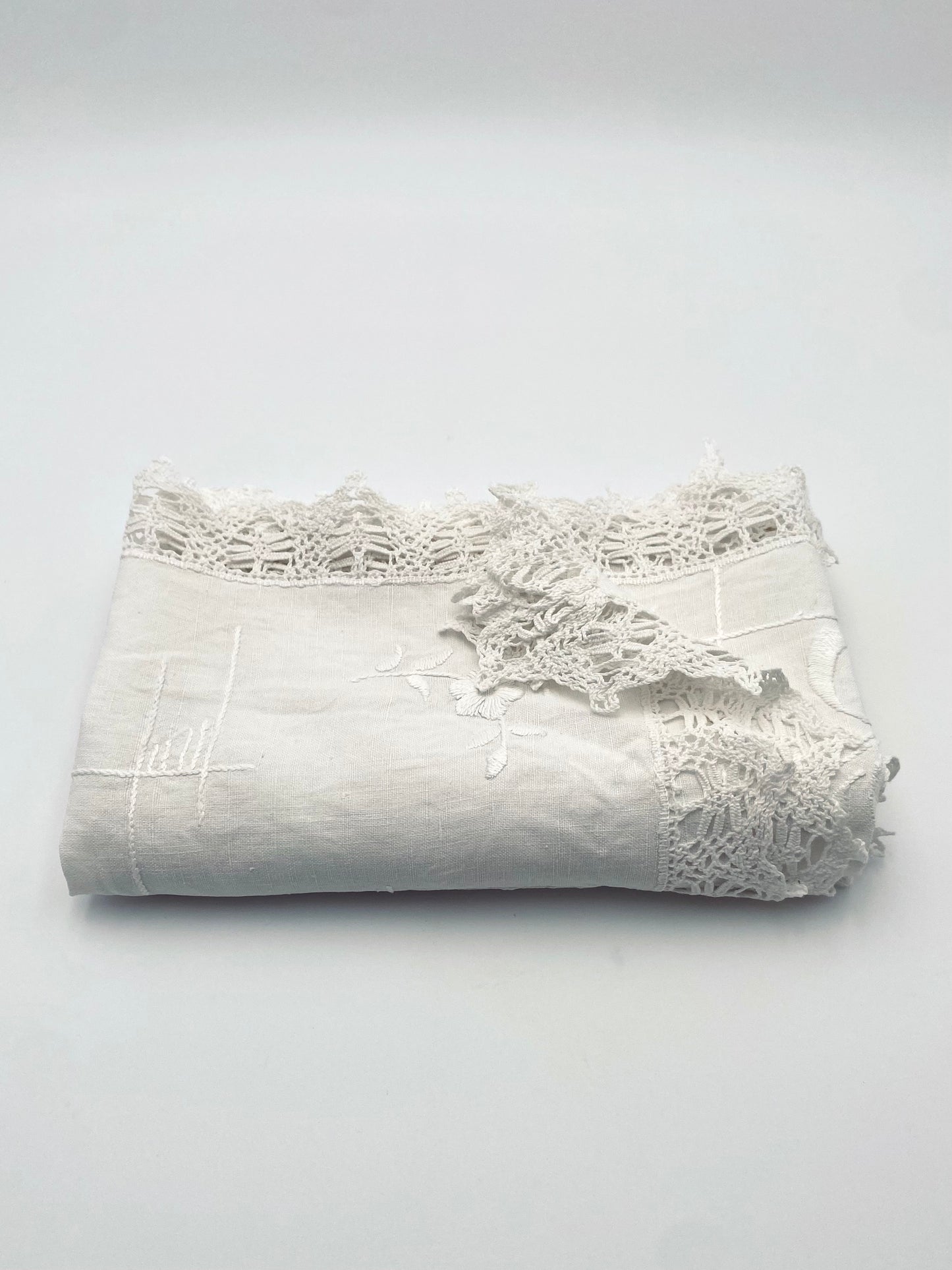 La petite nappe ancienne en lin à bordure de dentelle