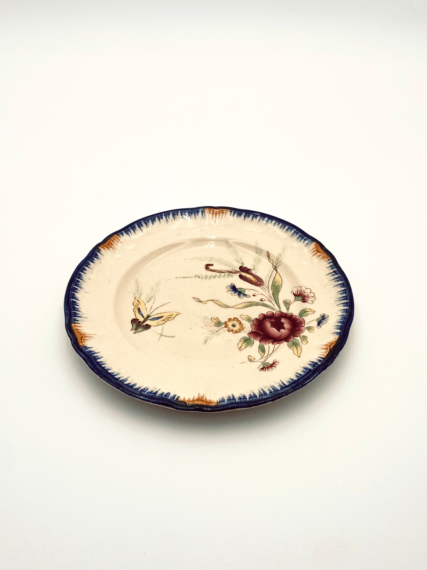 Le petite assiette avec un papillon et des fleurs
